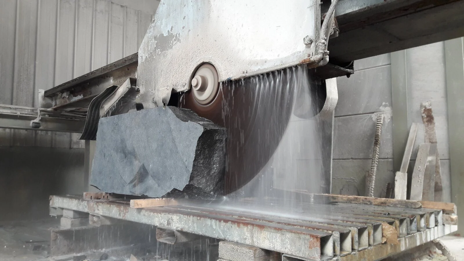 Bridge saw cutting a granite block